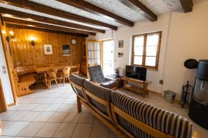 a living room with a couch and a table at Grazioso trilocale nel cuore di Folgaria in Folgaria