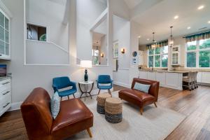 a living room with leather chairs and a table at 2251 Catesby's Bluff in Seabrook Island