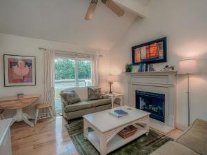 a living room with a couch and a fireplace at 1248 Creekwatch Villa in Seabrook Island