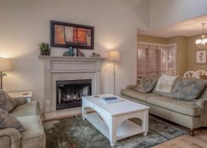 a living room with two couches and a fireplace at 1248 Creekwatch Villa in Seabrook Island