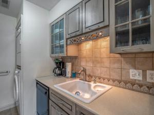 a kitchen with a sink and a refrigerator at 1248 Creekwatch Villa in Seabrook Island +20 photos