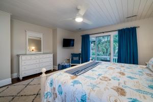 a bedroom with a bed and a dresser and a window at 2251 Catesby's Bluff in Seabrook Island