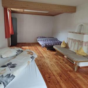 a room with two beds and a couch in it at Ferienwohnung Patrycja in Weissenbach am Lech