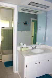 uma casa de banho com um lavatório e um espelho grande em 3609 Seabrook Island Road em Seabrook Island