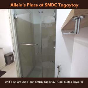 a shower with a glass door in a bathroom at Alleia's Place at Tagaytay in Tagaytay