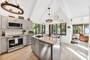 a kitchen with stainless steel appliances and a living room at 804 Treeloft Cottage in Seabrook Island