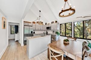 a kitchen with a wooden table and a dining room at 804 Treeloft Cottage in Seabrook Island +25 photos