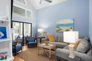 a living room with a couch and a table at 2766 Live Oak Villa in Seabrook Island