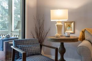 a living room with a table and a chair and a lamp at 2766 Live Oak Villa in Seabrook Island