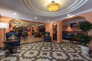 a lobby of a hotel with chairs and a table at HOTEL DE SAPA in Sa Pa