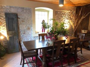 a dining room with a wooden table and chairs at Authentic Vila Nona by NYC Interior Architect in Susak