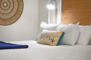 a bed with a pillow sitting on top of it at 1345 Pelican Watch Villa in Seabrook Island