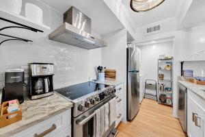 a kitchen with a stove and a refrigerator at 1345 Pelican Watch Villa in Seabrook Island