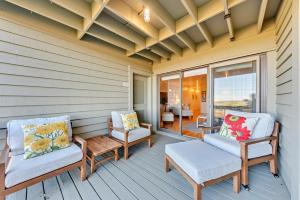 a porch with two chairs and a table at 1345 Pelican Watch Villa in Seabrook Island