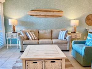a living room with a couch and a table at 1391 Pelican Watch Villa in Seabrook Island