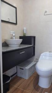 a bathroom with a white toilet and a sink at Apto en Coveñas cerca al mar in Coveñas