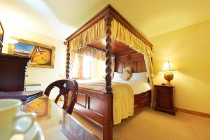 a bedroom with a bed and a dresser at Camden Arms Hotel in Royal Tunbridge Wells
