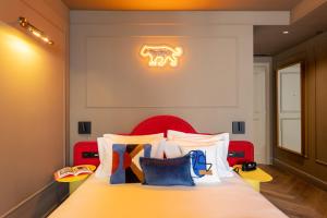 a bedroom with a bed with colorful pillows on it at Upon Angels - Adults Only in Lisbon