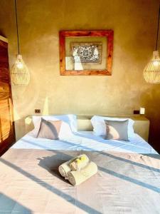 En eller flere senge i et værelse på Casa Maloya alberca y vista al mar