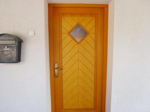 una puerta amarilla con una ventana en una casa en Apartment Jalps 1 in beautiful Bohinjska Bistrica en Bohinj