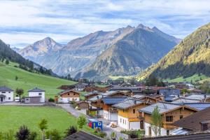 a village in a valley with mountains in the background at Landhaus MONTANA in Rauris