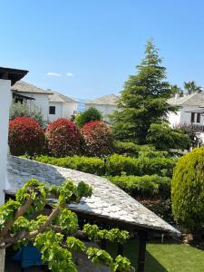 a garden with a stone walkway and a tree at BLUE DREAM in Koropi