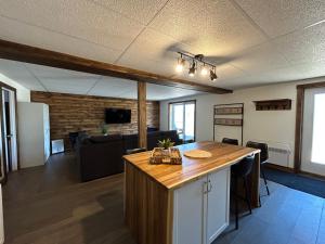 a living room with a kitchen and a dining room at Vébron 2 in LʼAnse-Saint-Jean