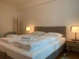 a bedroom with a bed with towels on it at one bedroom apartment in trendy Zurich West in Zürich