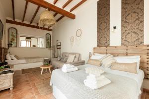 a bedroom with two beds and a living room at Casa Mistela in Jalón