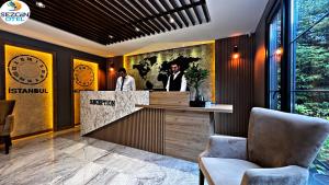 a lobby of a hotel with a reception desk at Sezgin Hotel in Uzungol