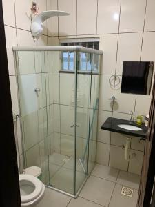a bathroom with a glass shower and a toilet at CARAVELAS in Três Marias +31 photos