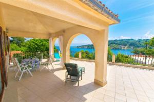 an outdoor patio with a view of the water at Apartment Ina in Rogač