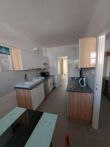 a kitchen with white cabinets and a counter top at Mala placa in Senj