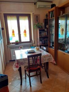 a kitchen with a table and chairs and windows at Room country-lake in Dormelletto