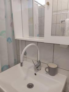 a kitchen sink with a faucet and a mirror at Mala placa in Senj +51 photos