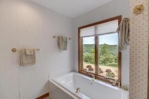 a white bathroom with a tub and a window at Vista Escote in Hot Springs