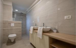 a bathroom with a sink and a toilet at Cozy Home In Grubine With Wifi in Grubine