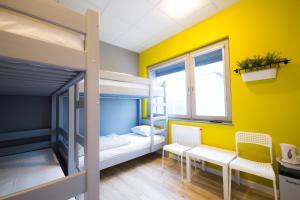 a small room with a bed and a window at Hostel Filip 2 in Gdańsk