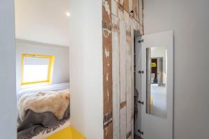 a bedroom with a bed and a door with a mirror at higgihaus Apartment 6 Clare Street Aparthotel Central Location in Bristol