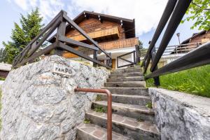 a set of stairs leading to a house at Grazioso trilocale nel cuore di Folgaria in Folgaria