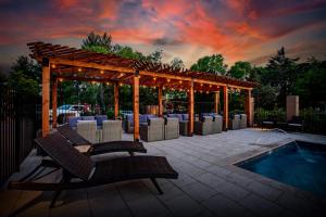 a patio with chairs and a gazebo and a pool at Arroyo Pinion Hotel, Ascend Hotel Collection in Sedona