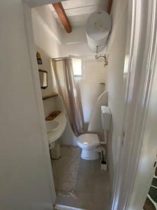 a small bathroom with a toilet and a sink at red2 guest house in Flampouria +9 photos