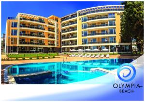 a swimming pool in front of a large building at Olympia Beach Complex in Ravda