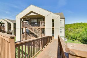 a boardwalk leading to a house with a balcony at Branson Escape with Pool Access, Grill and Balcony! in Branson