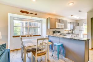 a kitchen and dining room with a table and chairs at Branson Escape with Pool Access, Grill and Balcony! in Branson