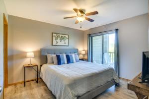 a bedroom with a bed and a ceiling fan at Branson Escape with Pool Access, Grill and Balcony! in Branson