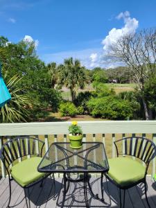 a table and two chairs on a balcony with a plant at 915 Sealoft Villa in Seabrook Island