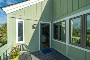 a home with green siding and a front porch at 915 Sealoft Villa in Seabrook Island