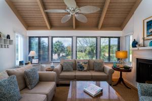 a living room with a couch and a ceiling fan at 915 Sealoft Villa in Seabrook Island +39 photos