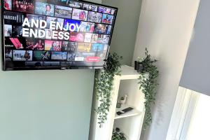 a flat screen tv hanging on a wall at Studio 38 - Urban Living in the Heart of Brighton in Brighton & Hove